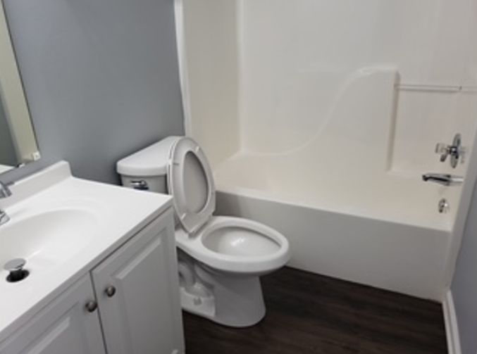 Freshly cleaned bathroom with spotless tub and vanity